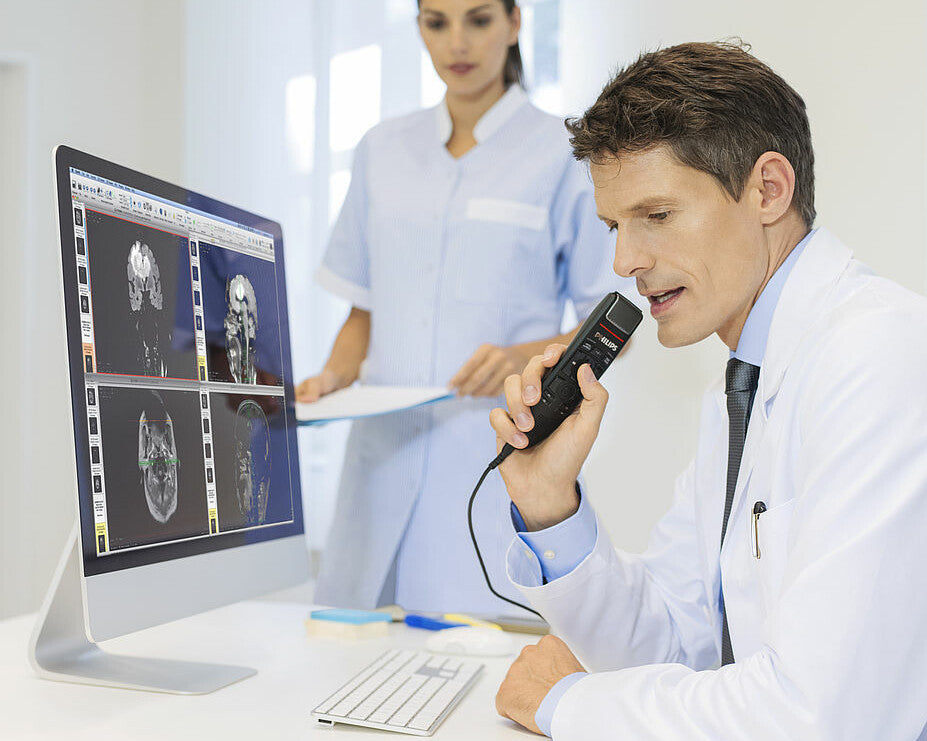 Male Physician with the Philips SpeechMike Premium Touch at His Desk